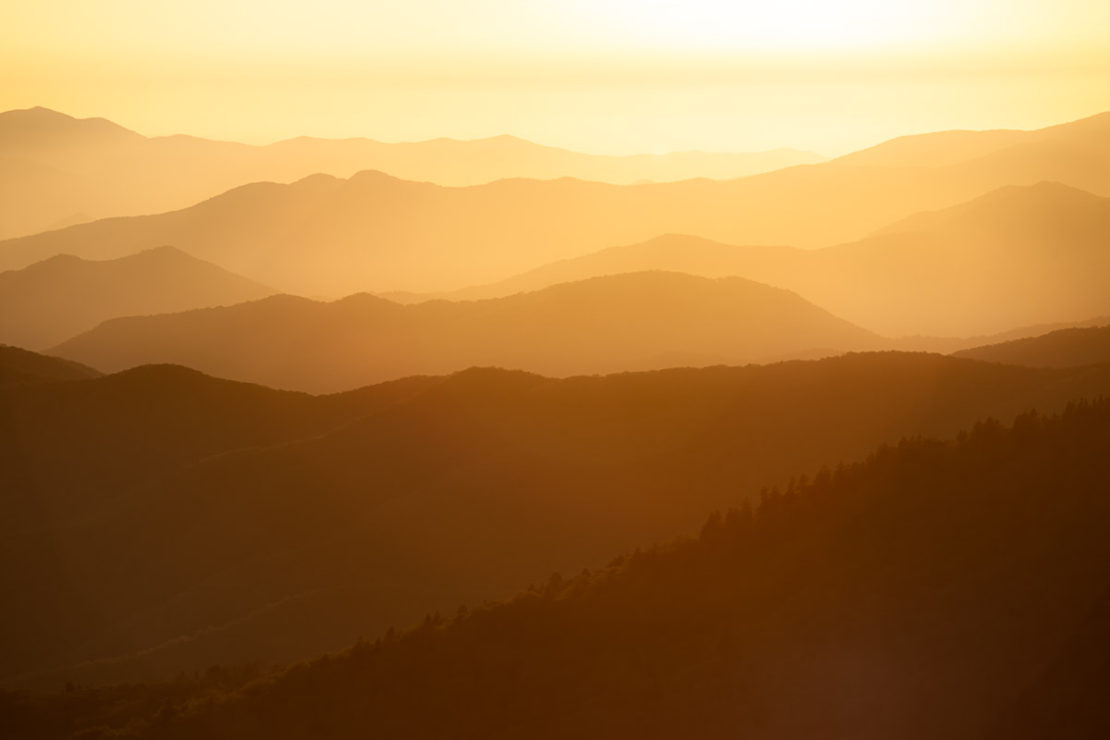 Soft layered fog over a calm distant horizon at dawn